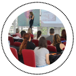 Auditorium with people listening to a lecture